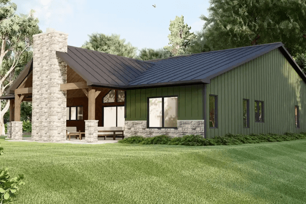 Expansive green lawn surrounding a modern barndominium.