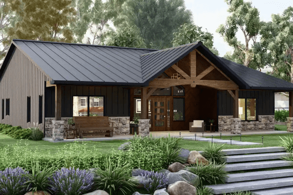 Rustic barndominium with stone accents and lush landscaping.