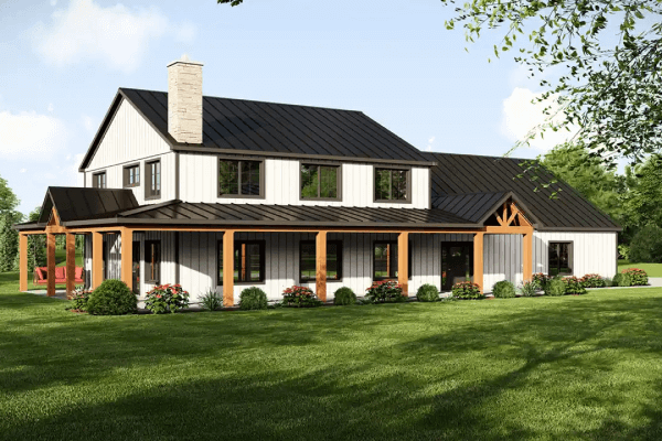 Two-story barndominium with a wraparound porch and garden.