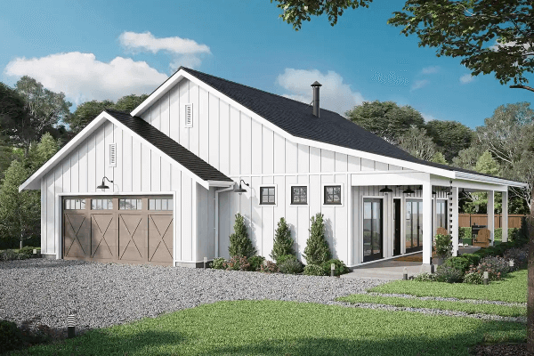 Sleek barndominium with a garage and well-maintained garden.