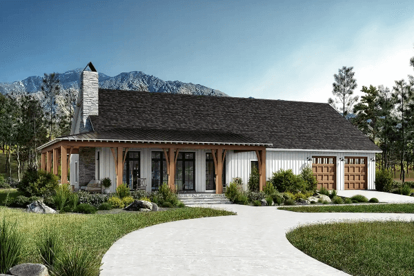 Barndominium with a scenic mountain backdrop and circular driveway.